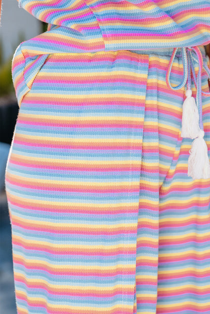 Chic pink striped rainbow tee and tasseled wide leg pants ensemble