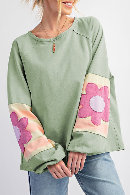 Floral patchwork oversized top with exposed seams in smoke green