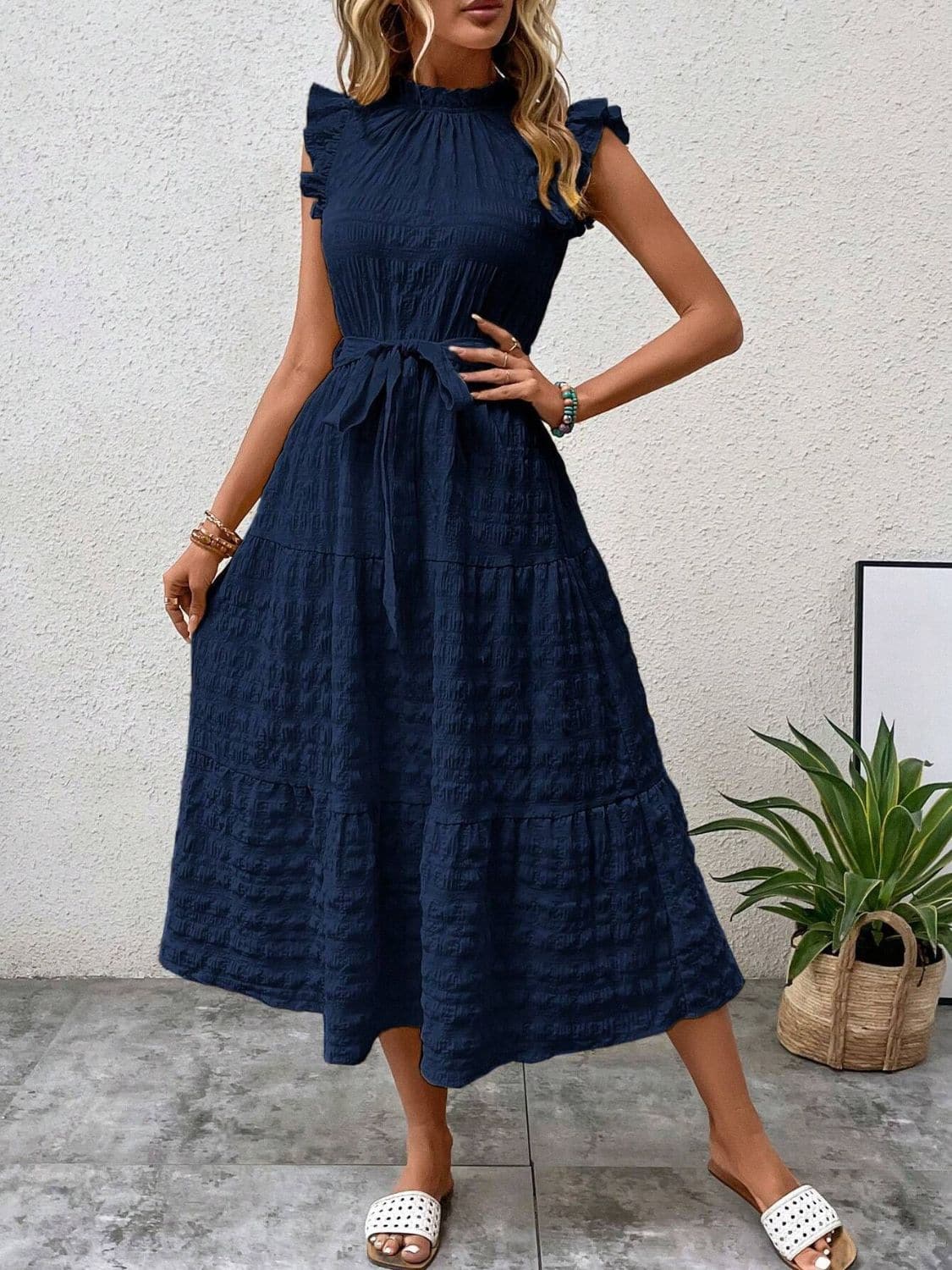 Ruffled cap sleeve midi dress in navy blue with tie waist.