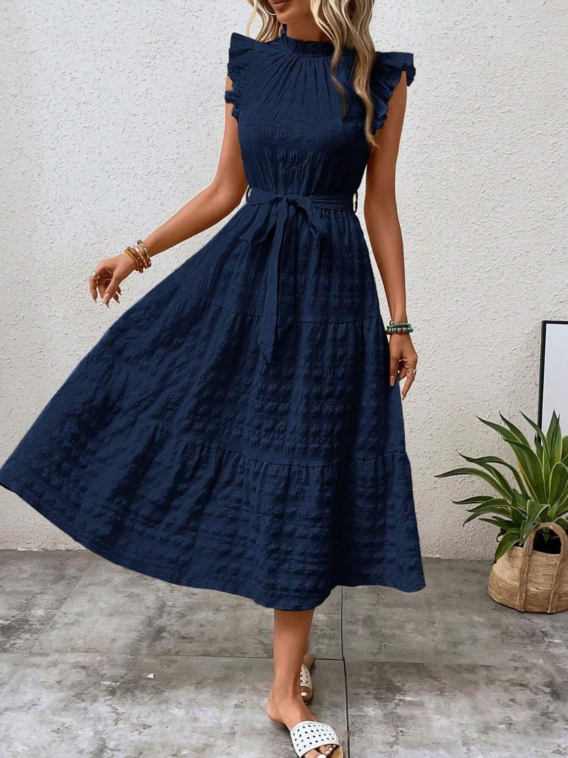 Ruffled cap sleeve midi dress in navy blue, featuring a tied waist with no stretch material.