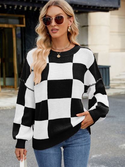 Black and white checkered round neck long sleeve sweater with a casual style.