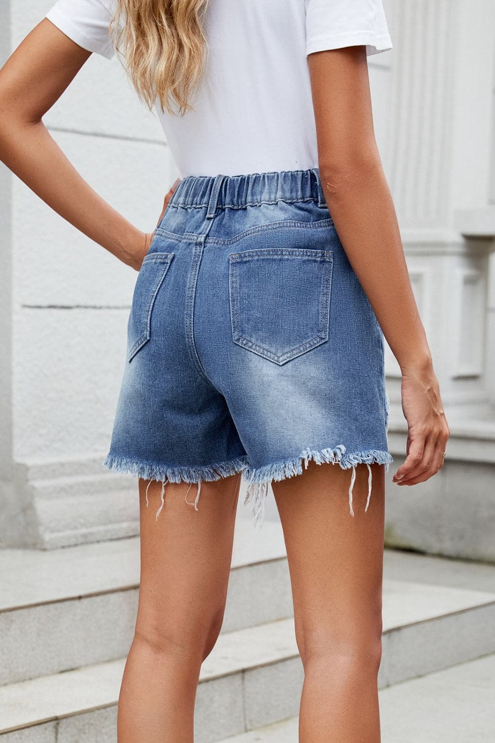 Distressed Raw Hem Asymmetric Waist Denim Shorts.