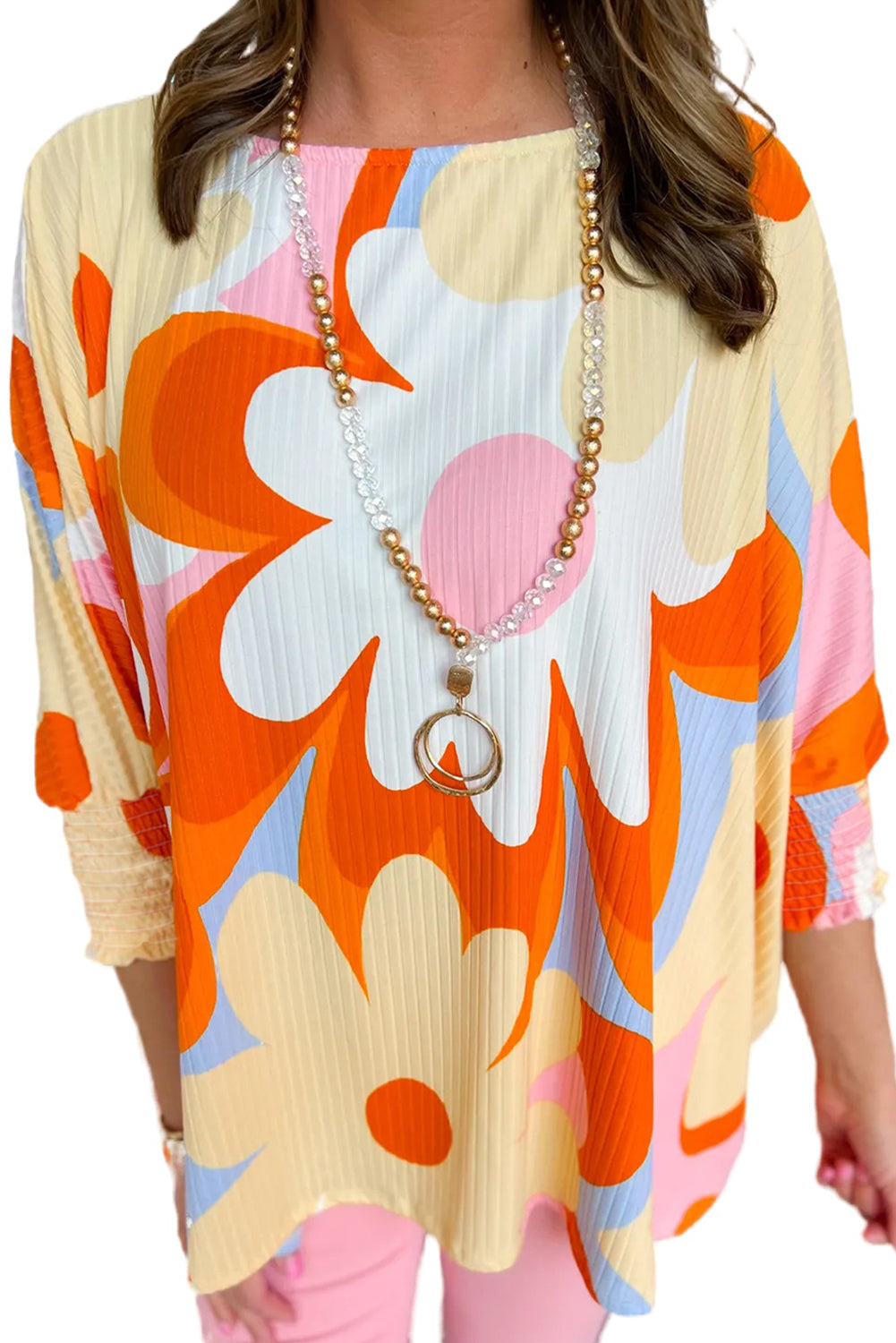 Floral charm: Yellow ribbed blouse with shirred sleeves