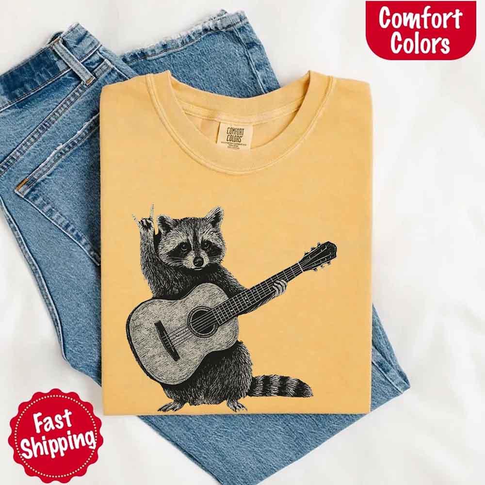 Adorb Custom Tees Raccoon T-shirt, a unique musician gift with a durable funny animal print on Comfort Colors fabric.