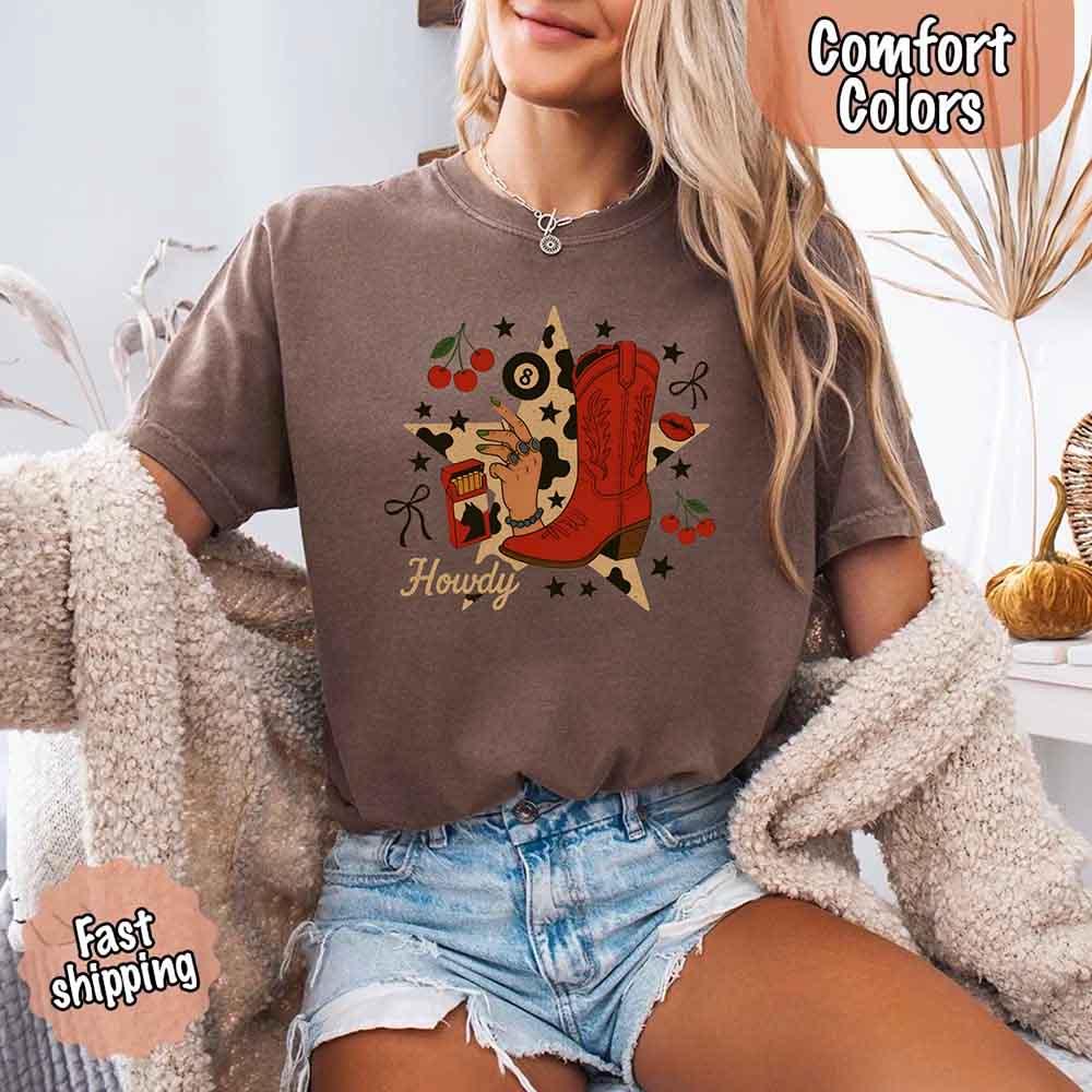 Adorb.co Howdy Cowgirl Star Collage Comfort Shirt worn by a model, showcasing its relaxed fit and casual fashion appeal.