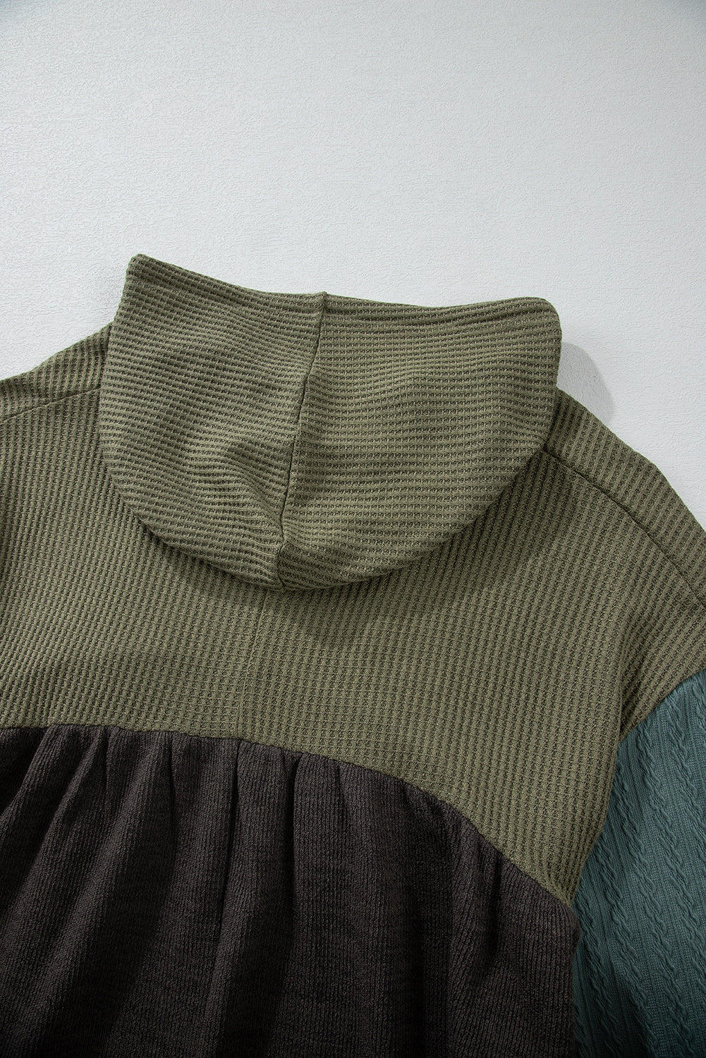 Laurel green colorblock patchwork hooded top with frayed high-low hem