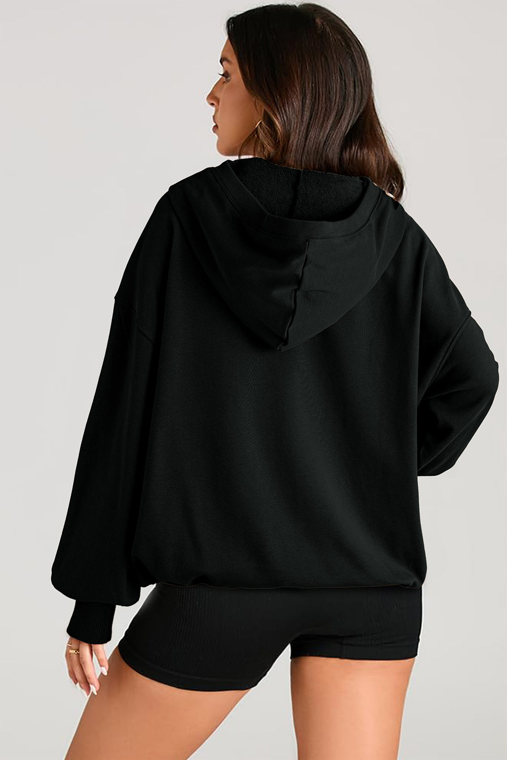 Cozy black oversized hoodie with kangaroo pocket and half zipper