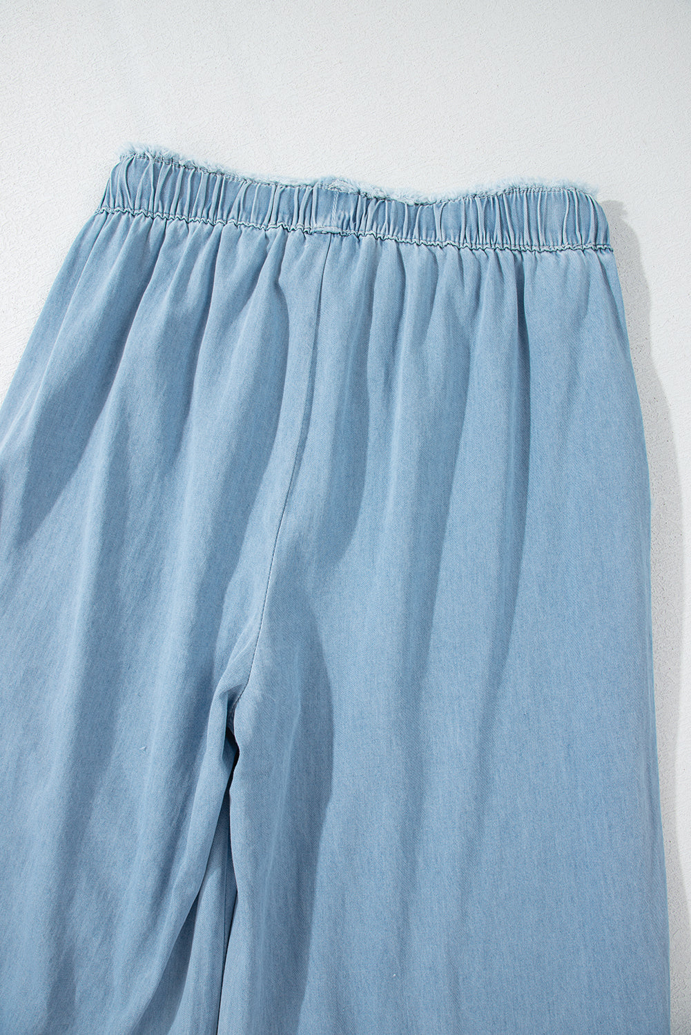 Myosotis light wash ruffled wide leg jeans with raw hem detail