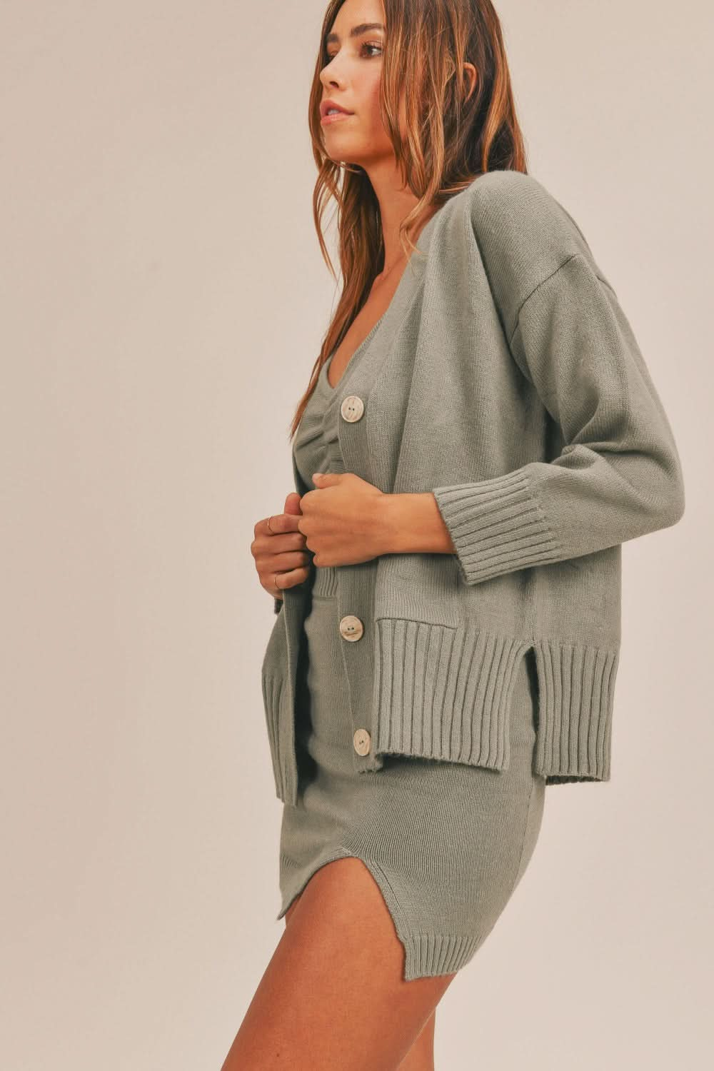 Chic three-piece sweater set with crop top, mini skirt, and cardigan