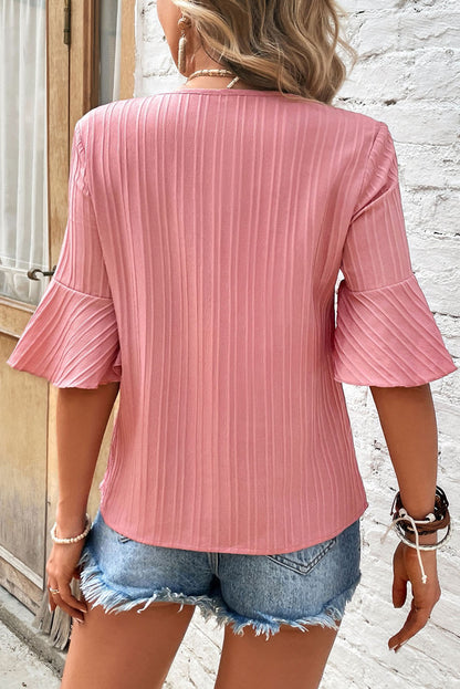 Peach blossom textured plus top with ruffled sleeves and V-neck