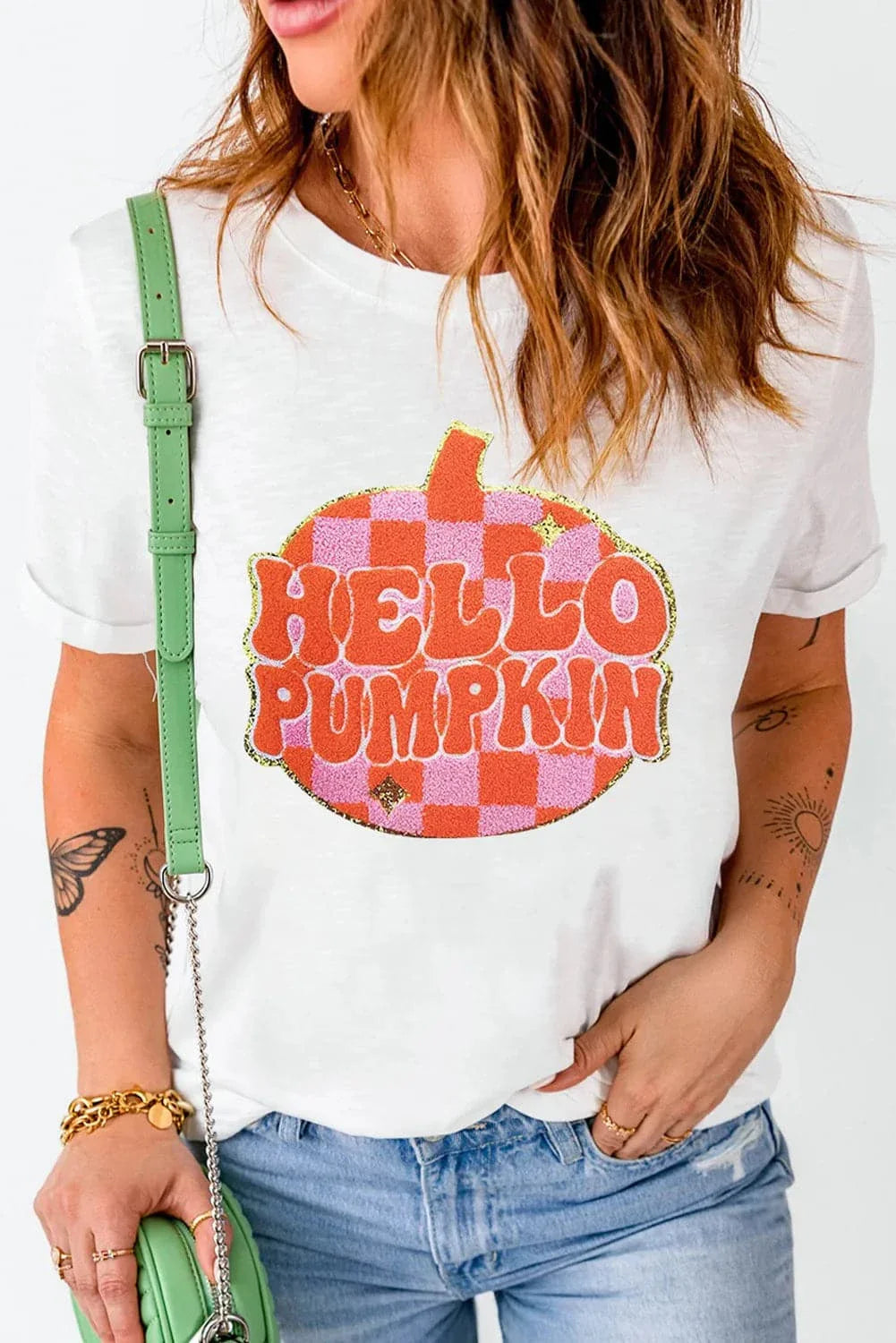 Glitter pumpkin tee with round neck and short sleeves for a flattering fit.