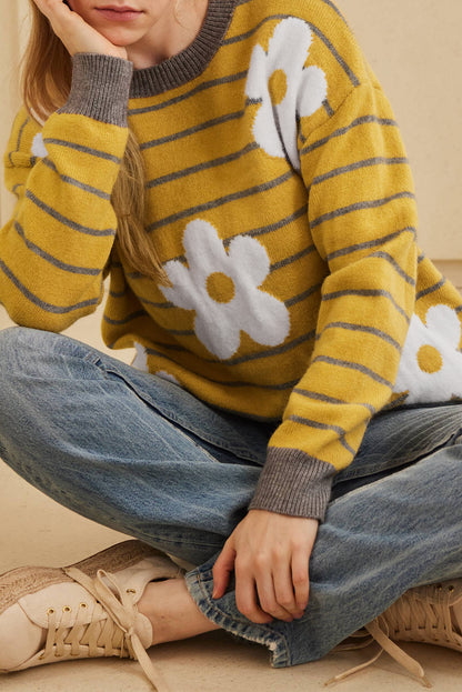 Yellow sweater with striped pattern and daisy floral design, round neck and dropped shoulders.