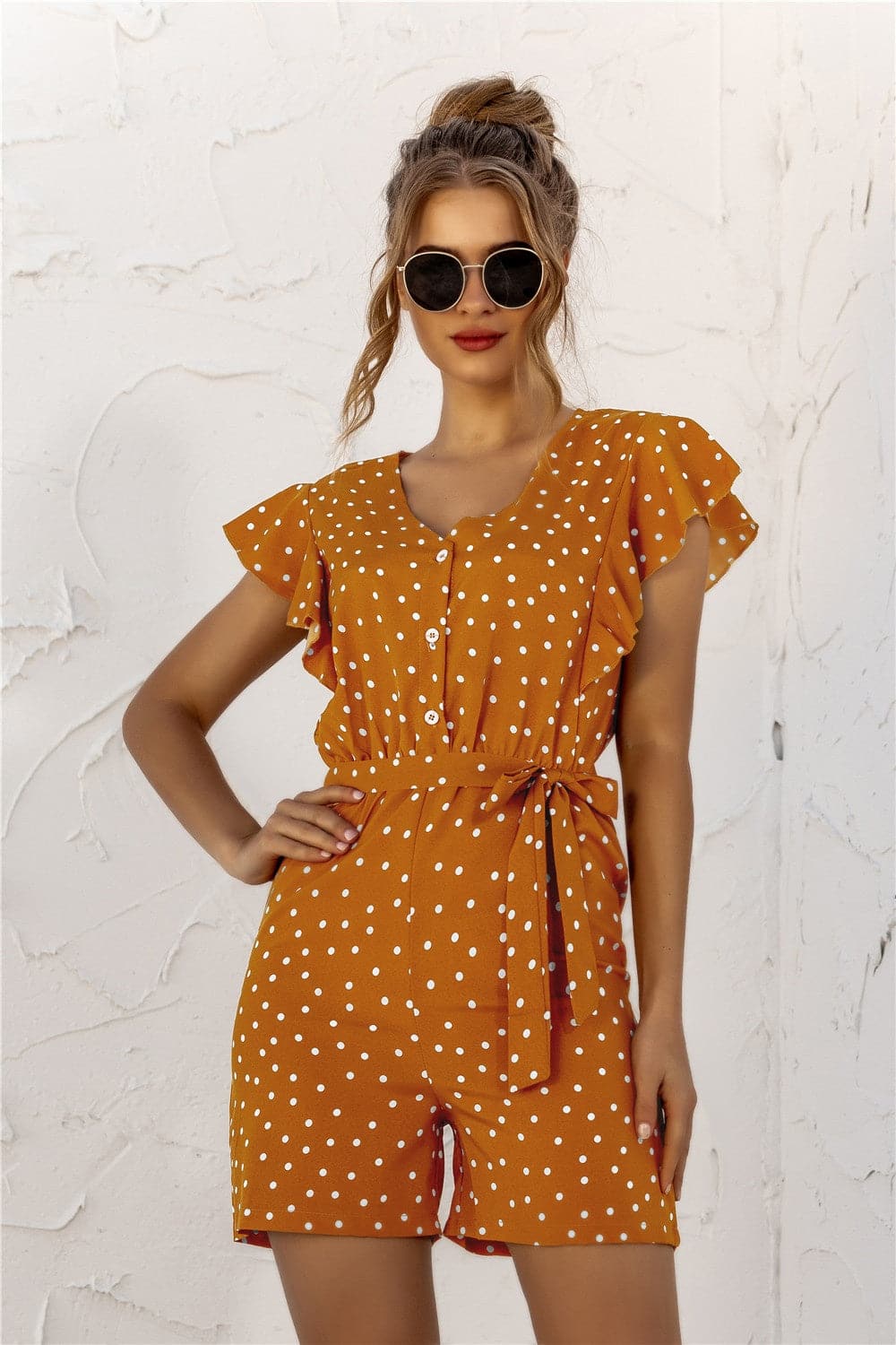 Ruffled Polka Dot Half Button Romper.