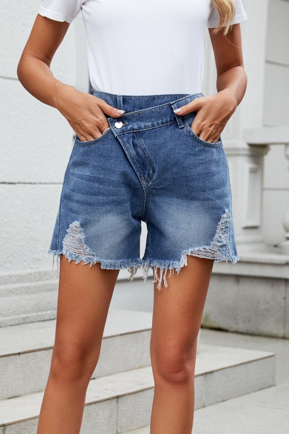 Distressed Raw Hem Asymmetric Waist Denim Shorts.