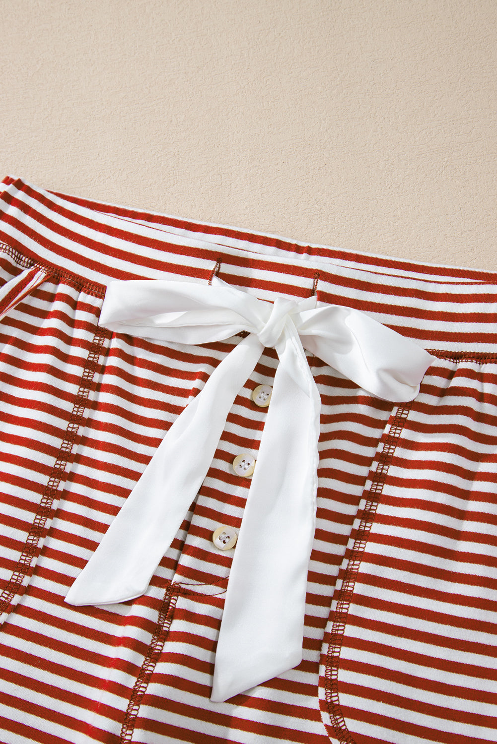 Chic red striped lounge set with buttoned V-neck top and knotted waist pants