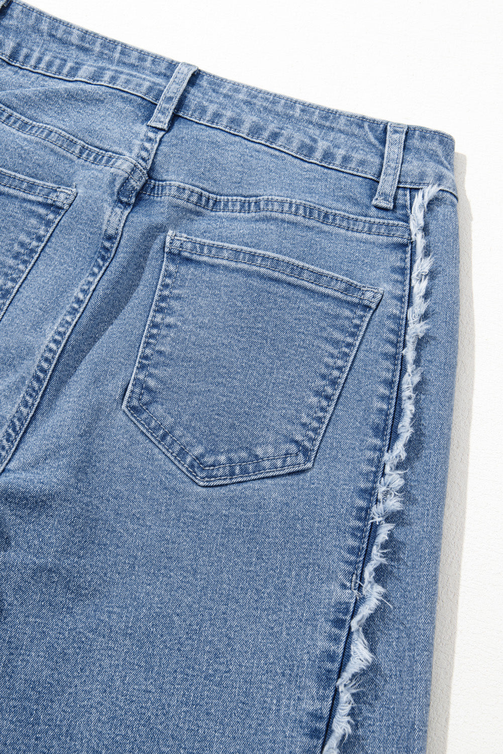 Vintage-inspired Beau Blue flared jeans with raw hem detailing