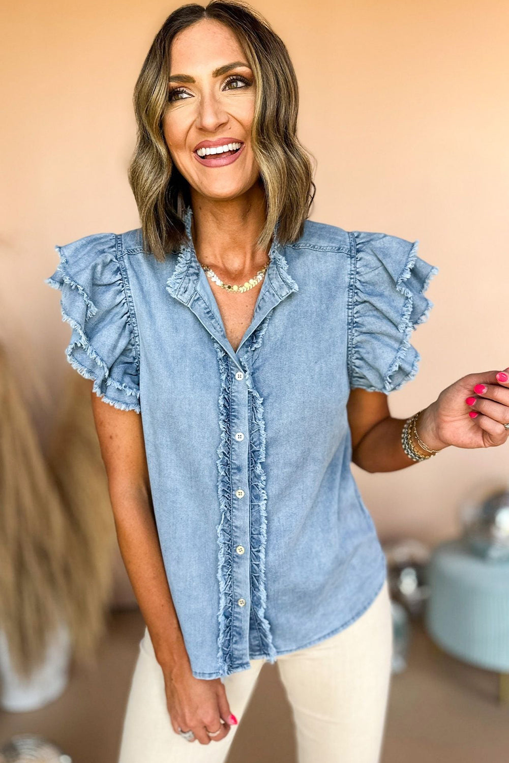 Chic ruffled denim top with button front and frayed hem