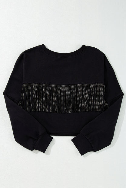 Sparkle on game day with a black cropped rugby sweatshirt featuring tassels and sequins