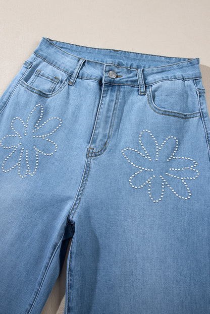 Light blue high-rise wide leg jeans with floral rhinestone embellishments