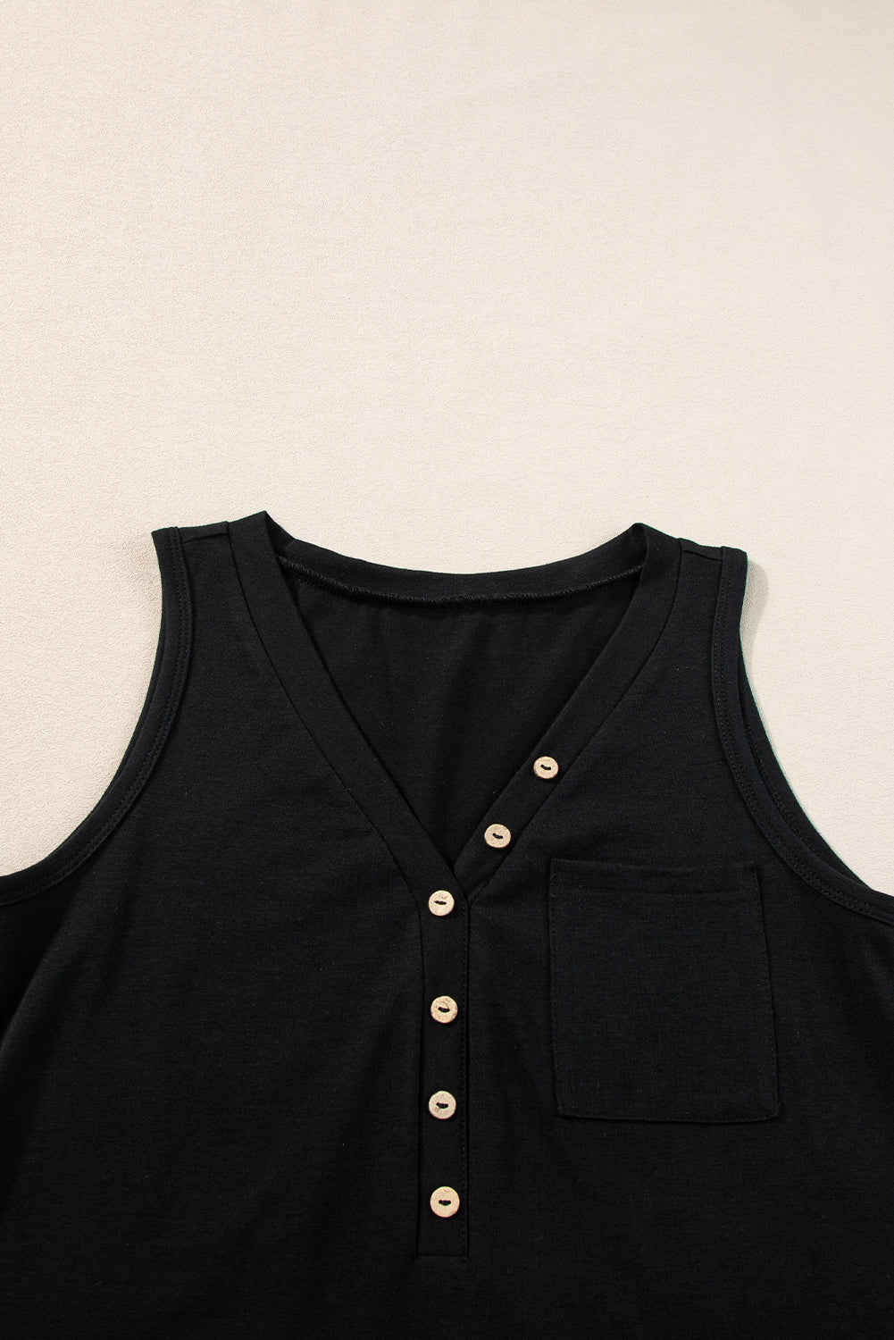 Chic black v-neck tank top with half buttons and patched pocket