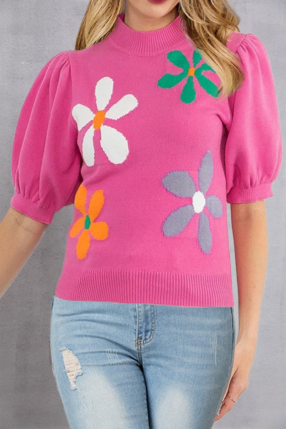 Floral mock neck pullover top in pink with colorful flower patterns.