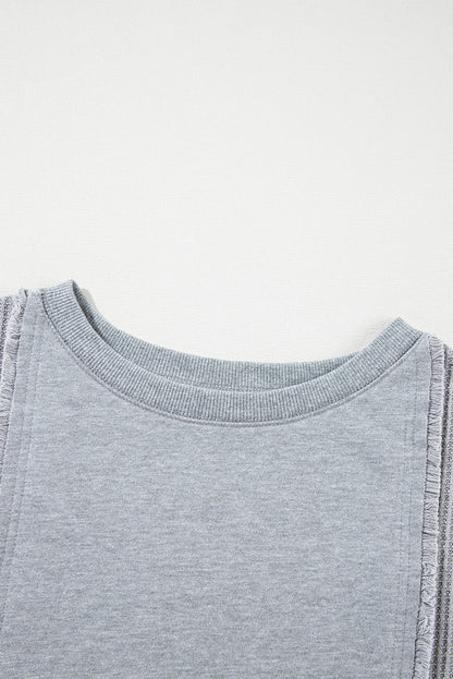 Chic light grey waffle patchwork pullover with raw hem details