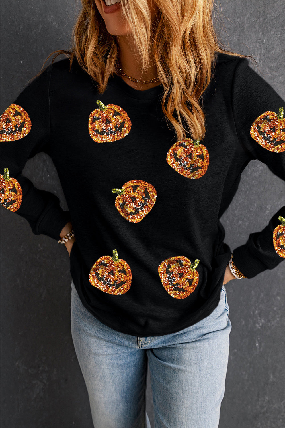 Sparkling pumpkin face pullover for a spooky Halloween look