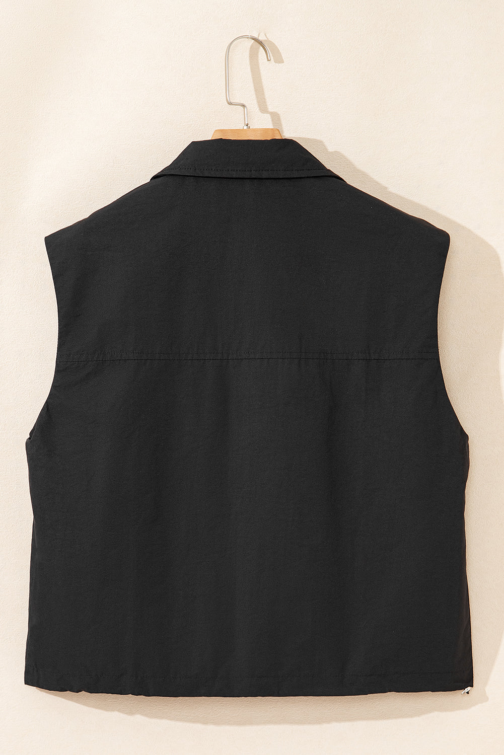 Chic black high neck vest with zip-up front and flap pockets