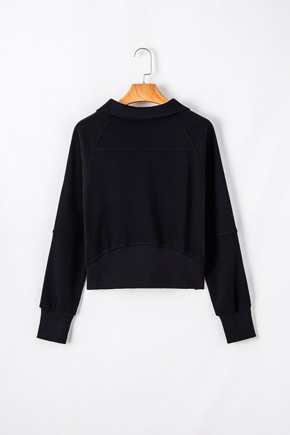 Chic black quarter zip sweatshirt with kangaroo pocket