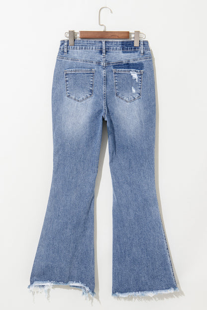 Dusk blue high-waisted flared jeans with distressed hem and ripped details