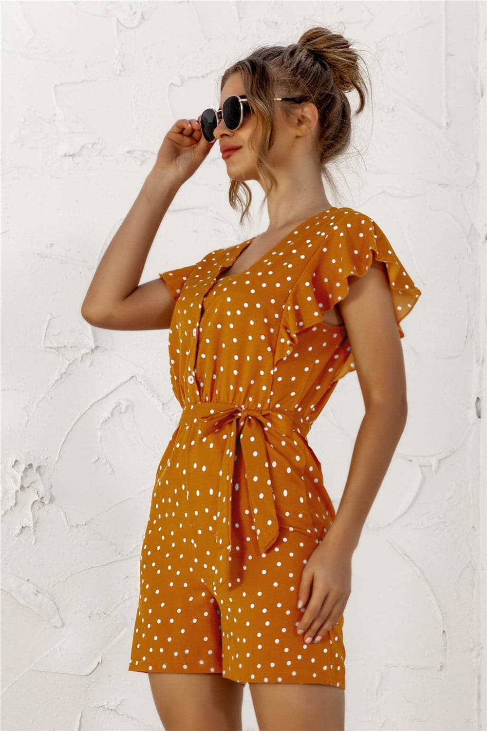 Ruffled Polka Dot Half Button Romper.