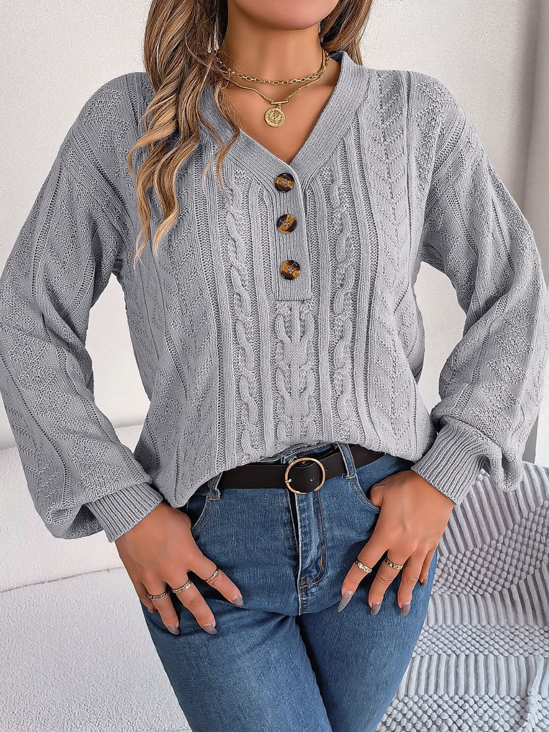 Chic cable-knit v-neck sweater with buttoned details