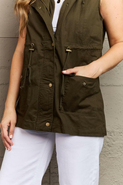 Zenana More To Come Full Size Military Hooded VestExperience the Perfect Blend of Style and Functionality
 Introducing the Zenana More To Come Full Size Military Hooded Vest, where rugged charm meets cozy comfort. TLove Salve Full Size Military Hooded Vestcloseout