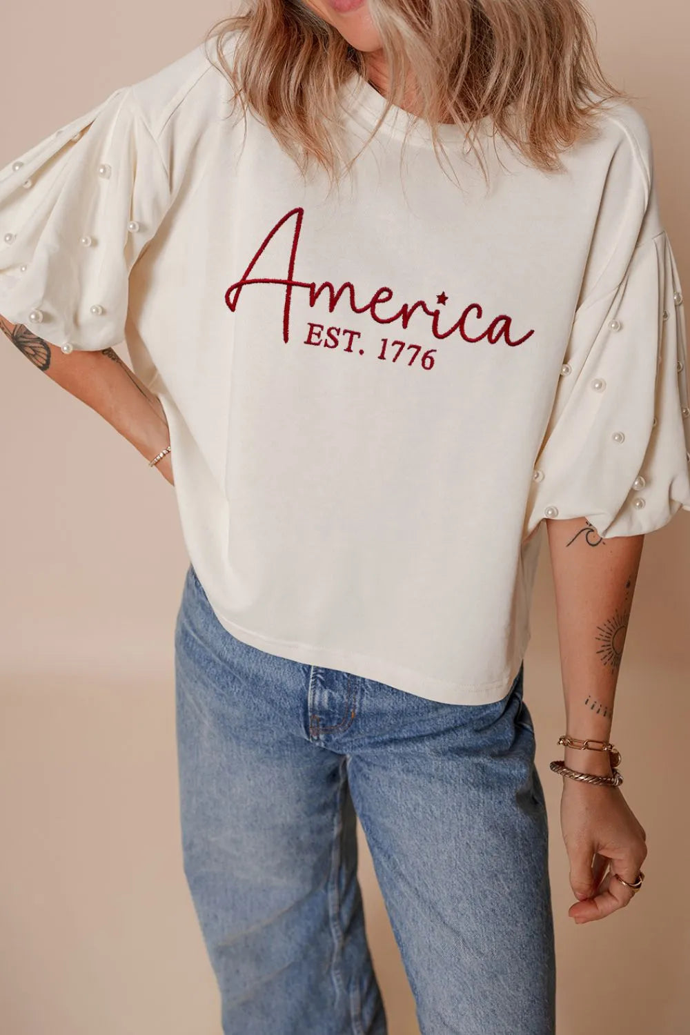 AMERICA EST 1776 Embroidered Pearl Beaded Sleeve T Shirt - Product back view by Simply Love