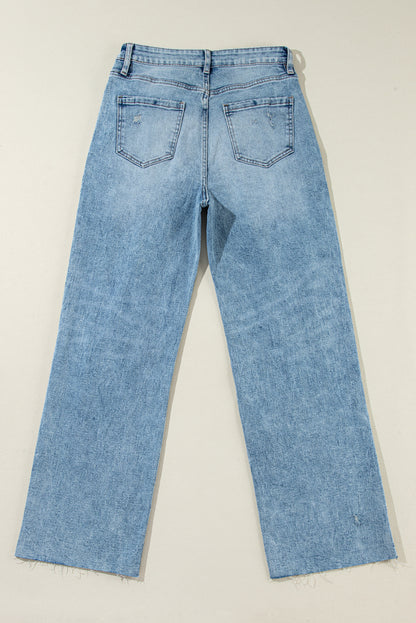 Trendy light blue distressed straight leg jeans with raw hem