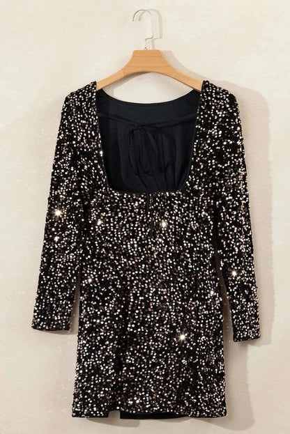 Backless sequin party dress with long sleeves on hanger.