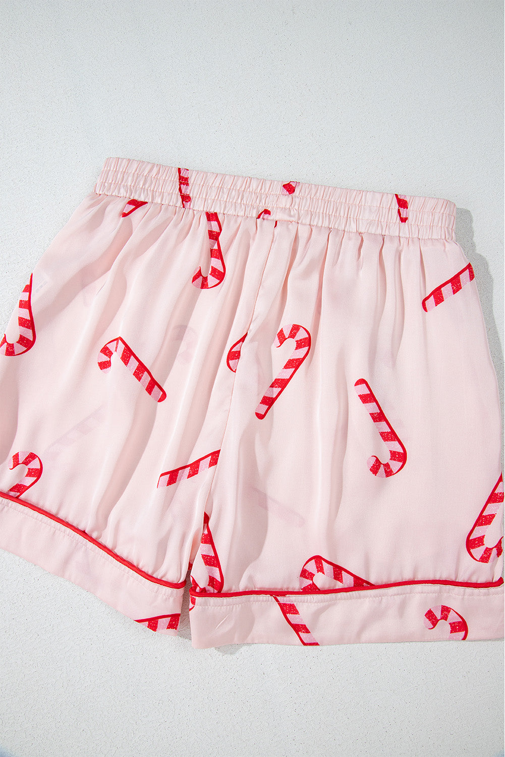 Pink candy cane print holiday pajama set with shirt and shorts