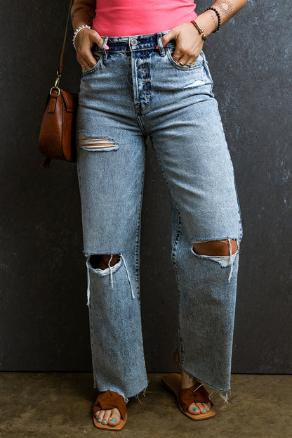 Trendy light blue distressed straight leg jeans with raw hem