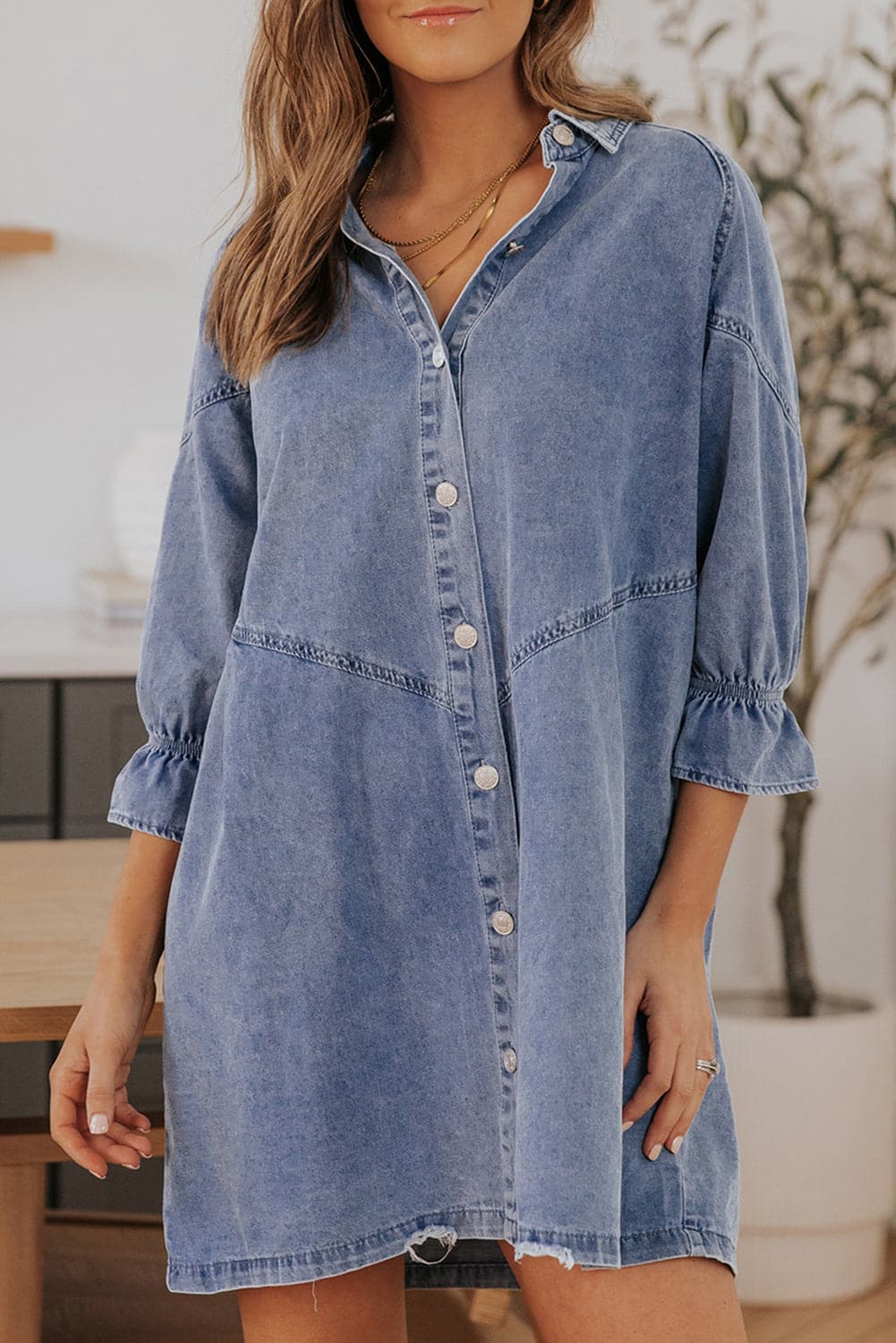 Chic denim mini dress with flounce sleeves, buttoned front, and collared neck.