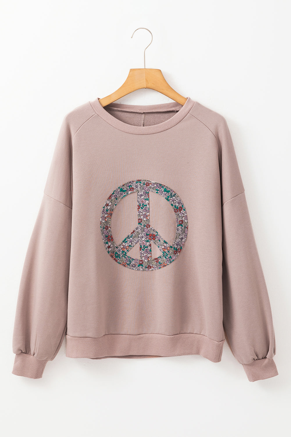 Floral peace symbol drop shoulder sweatshirt for a stylish and cozy look