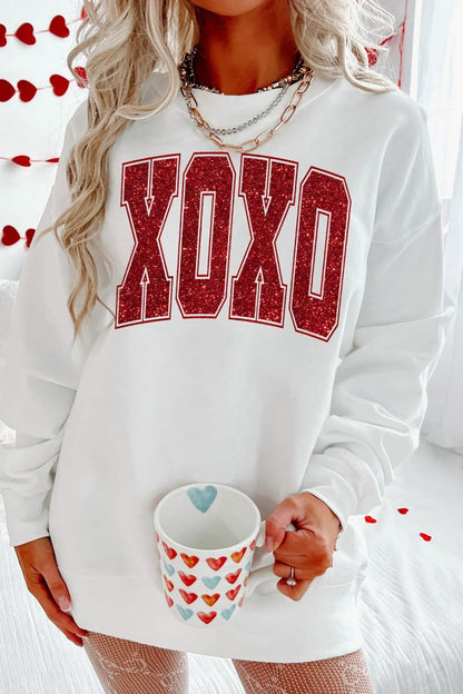 Valentine’s Day XOXO Glitter Round Neck Sweatshirt with festive design and comfortable fit.