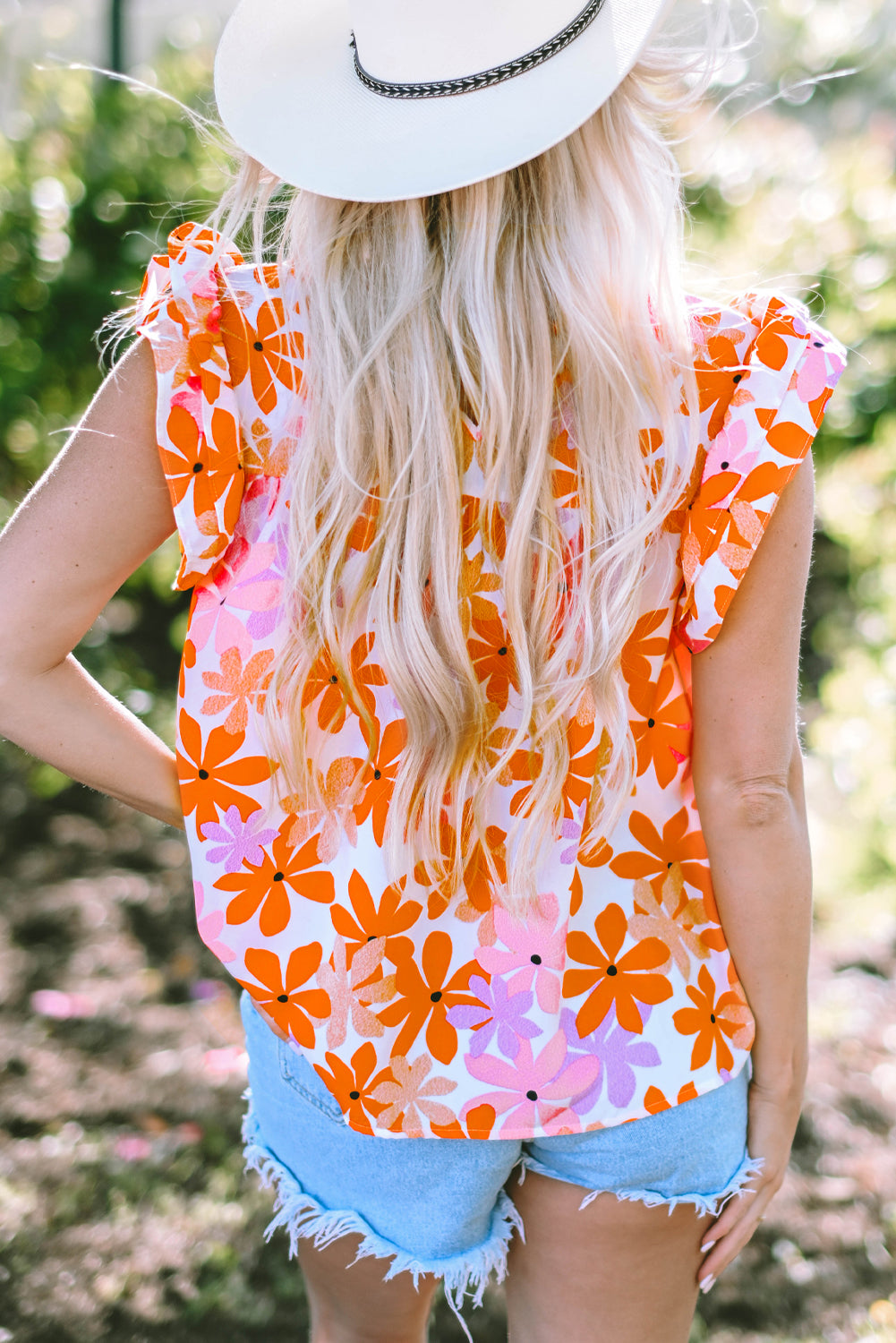 Floral delight: Orange ruffled sleeve top with smocked detail