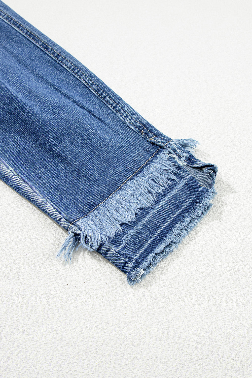 Retro light blue frayed ankle skinny jeans with a distressed finish