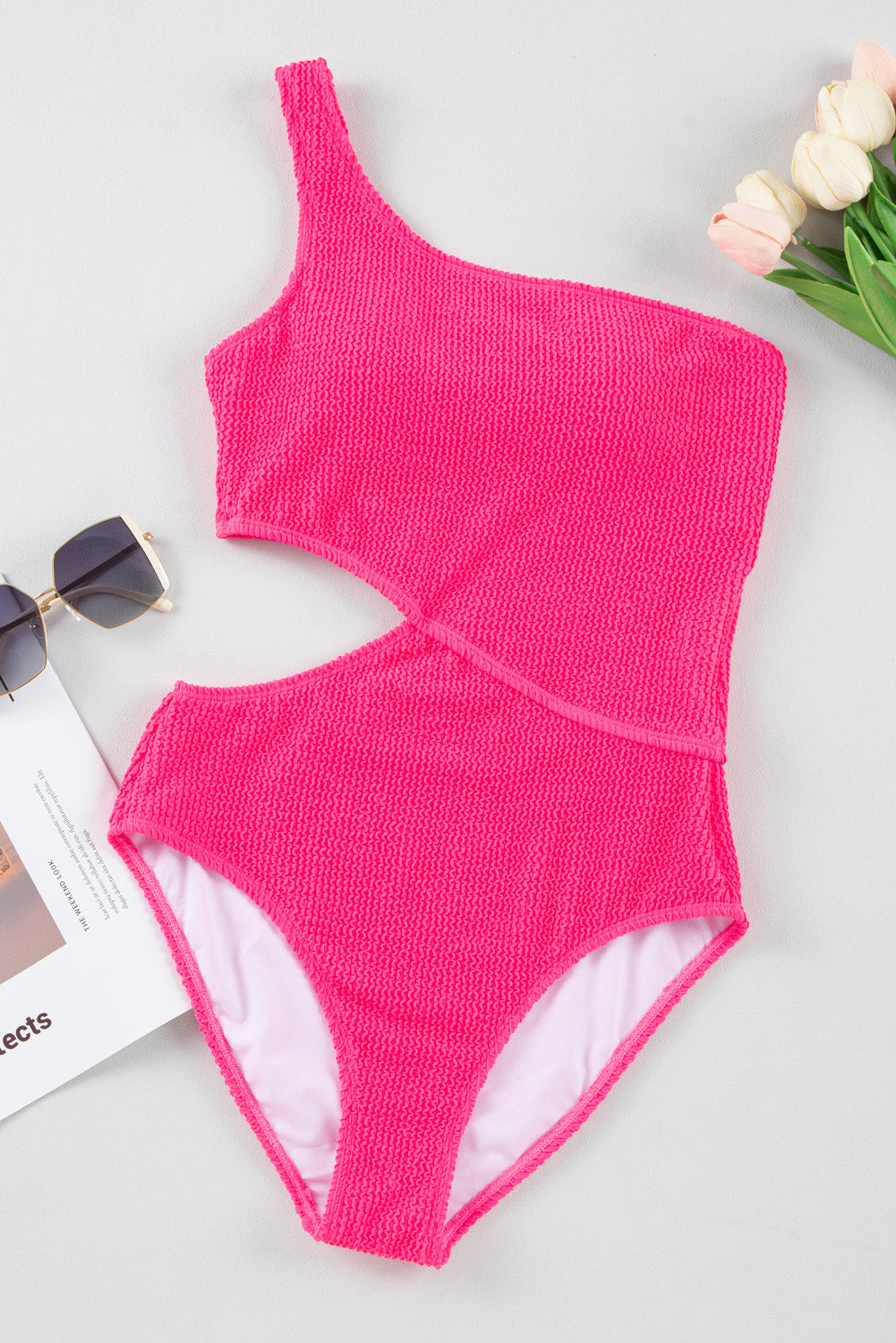 Bold bright pink textured one-shoulder monokini with cut-out design