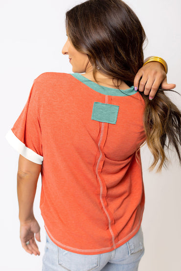 Grapefruit orange exposed seam V-neck tee with contrast trim