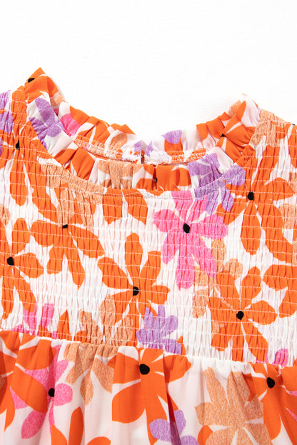 Floral delight: Orange ruffled sleeve top with smocked detail