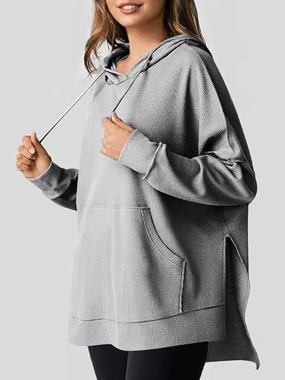 Sleek pocketed hoodie with drawstring and side slit