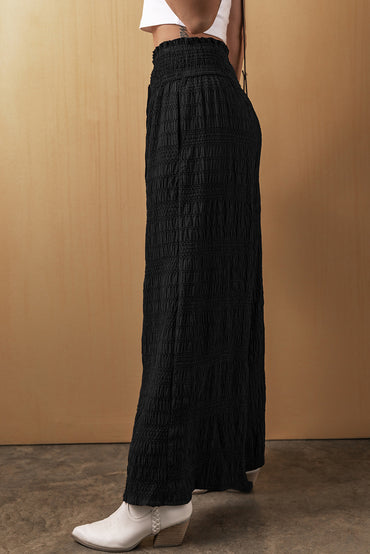 Relaxed black textured smocked waist wide-leg pants