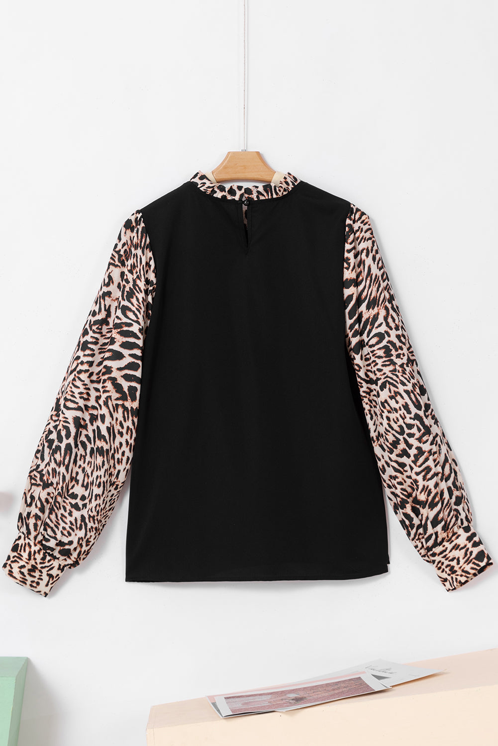 Elegant black lantern sleeve blouse with leopard print accents