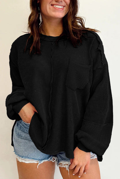 Chic black crinkle patchwork top in plus sizes with exposed seams